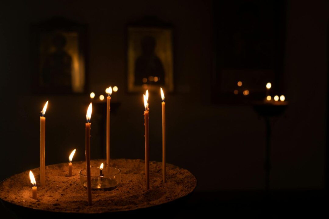 candles in orthodox place with icons